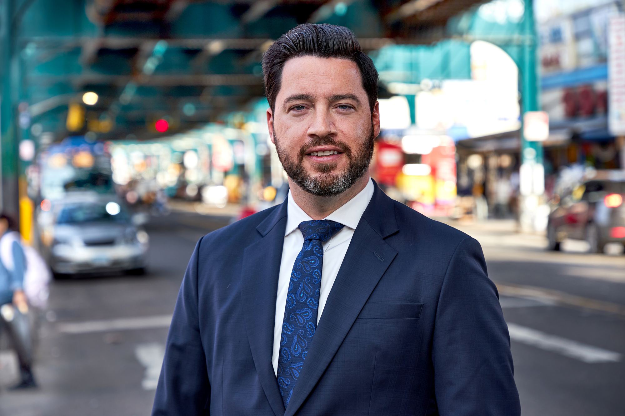 Robert A. Miklos on a Queens street beneath the elevated train